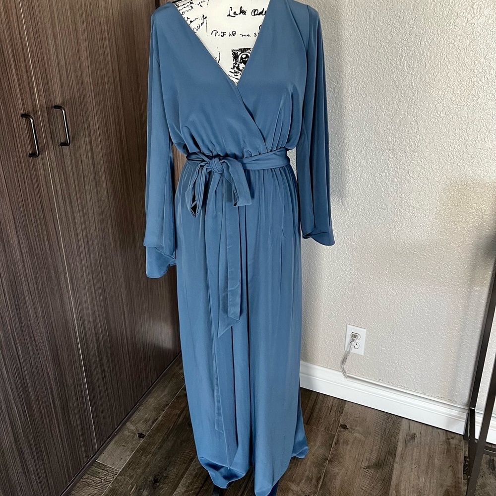 Long sleeve jumpsuit with tie sash.